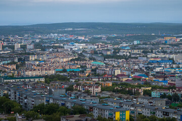 Fototapeta na wymiar Morning cityscape. Top view of the buildings and streets of the city. Residential urban areas at dawn. Beautiful aerial city landscape. Petropavlovsk-Kamchatsky, Kamchatka Krai, Far East of Russia.