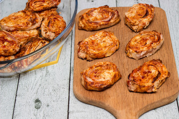 Homemade mini pizza buns topped with tomato sauce, ham and cheese