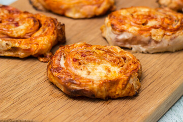 Homemade mini pizza buns topped with tomato sauce, ham and cheese