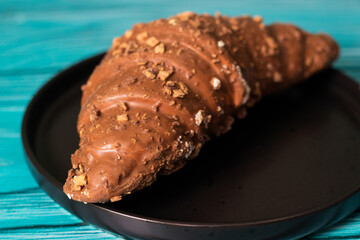 Freshly chocolate croissant on plate