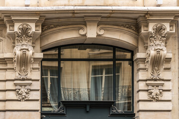 Traditional old French house: balconies and windows. Paris, France.