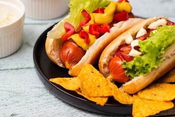 Hot dogs with different toppings on a table