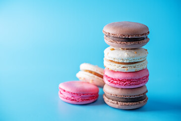 Sweet multicoloured macarons on a bright background