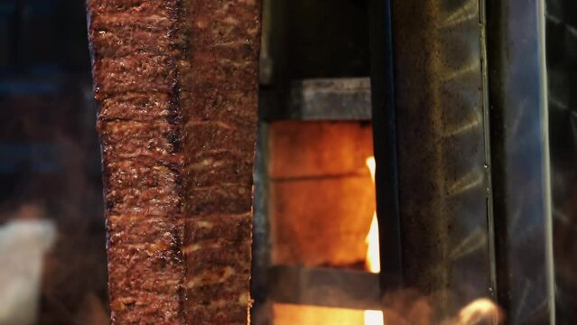 Meat doner cut close-up videos, cutting hanging doner. Turkish kebab iskender. Shawarma meat being cut before making