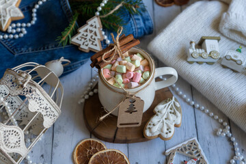 A cup of hot coffee, zifirki, sweets and Christmas decorations on a wooden table. Calendar for New Year 2023.