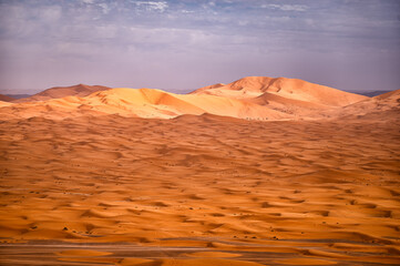 Naklejka na ściany i meble Sahara Desert sand dunes background. Popular travel destination, Erg Chebbi, Sahara Desert, Morocco.