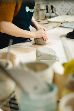 Close Up Of A Person Working In A Ceramic Studio Making A Pinch Pot From Clay Hand-built 