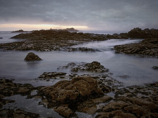 Rocky beach at sunset or dusk