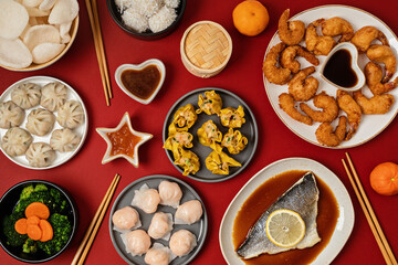 Chinese new year festival table over red background. Traditional lunar new year food. Flat lay, top view