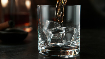 Pouring whisky into glass.