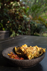 Omelet served with red chili sauce