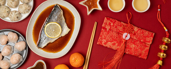 Chinese new year festival table over red background. Traditional lunar new year food. Flat lay, top...