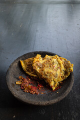 Omelet served with red chili sauce