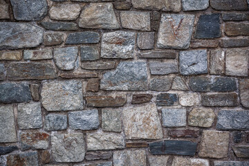 Irregular shaped natural stone background in shades of grays, browns, beige and white