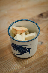 Top view of ceramic tools and makeup foam brushes on wooden background in ceramic studio side angled view in old cup