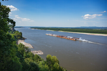 Coal barge floating down the Mississippi River from the scenic overlook at the Trail of Tears State Park in Cape Girardeau, Missouri - 551648191