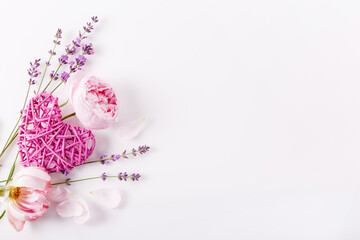 Valentine's Day background. Pink roses, lavender and purple heart on white background. Valentines day concept. Flat lay