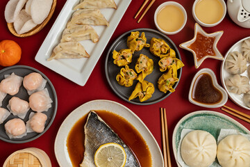 Chinese new year festival table over red background. Traditional lunar new year food. Flat lay, top view