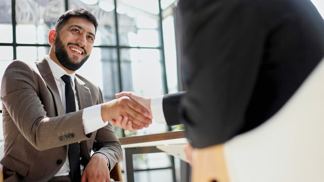 Business shaking hands, finishing up meeting. Successful businessmen handshaking after good deal.