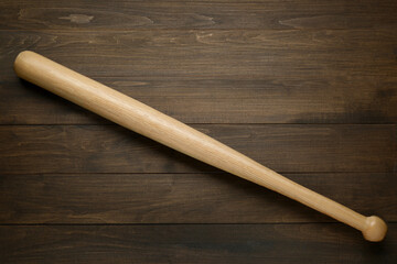 Baseball bat on wooden table, top view. Sports equipment