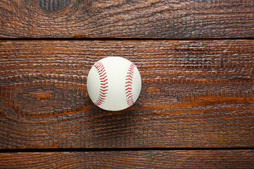Baseball ball on wooden table, top view with space for text. Sportive equipment