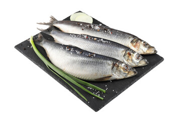 Slate plate with salted herrings, spices and onion isolated on white