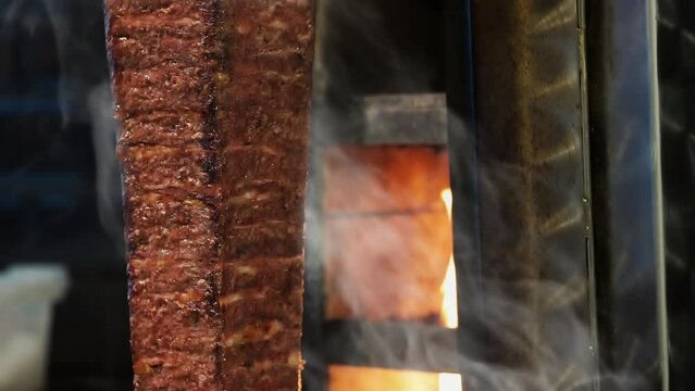 Meat doner cut close-up videos, cutting hanging doner. Turkish kebab iskender. Shawarma meat being cut before making