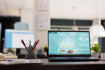 Investment application displays the stock market chart on the computer screen and advises the...