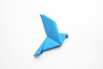 Beautiful blue origami bird on white background, top view