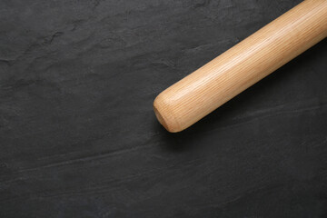 Baseball bat on black background, top view with space for text. Sports equipment