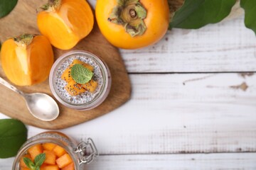 Delicious dessert with persimmon and chia seeds on table, flat lay. Space for text