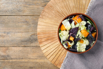 Delicious salad with Chinese cabbage, tomato and basil on wooden table, top view. Space for text