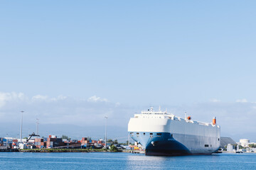 Obraz premium Guadeloupe, Pointe-à-Pitre - November 12 2022: Docked Marvelous Ace ship. Vehicles Carrier sailing under flag of Japan on Caribbean waters