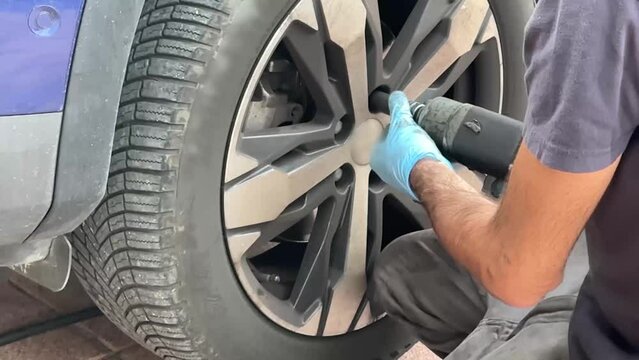 Tire dealer changes a car tire