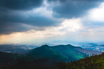 mountains surrounded by city with gray cloud sky in sierra de guadalupe tultitlan 