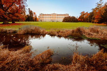 Monza's Villa Reale in autumn with tourists and small waterway in the foreground