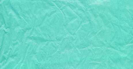 Crumpled wrapping paper in a delicate blue color. Background with paper texture effect