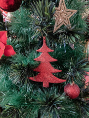 Christmas tree decorated with colorful props, stars of golden and silver color 