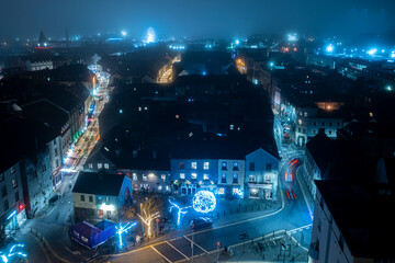 Aerial view of Galway city center on a foggy night with the street christmas light on