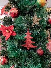 Fototapeta na wymiar Christmas tree decorated with colorful props, stars of golden and silver color 