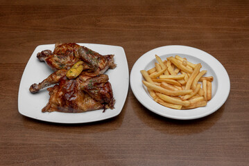 Terrific Lemon Roast Chicken halved with crispy skin and a side of fries