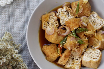 Tahu gejrot is traditional street food made from fried tofu (bean curd) with crushed shallot and...