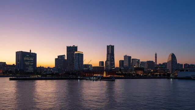 Panning timelapse of Yokohama Minato-Mirai panoramic view from dusk to night.