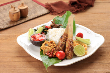 Nasi Campur Bali, Indonesian Balinese Rice with Sate Lilit, Ayam Sisit, Sambal Matah, and Peanut