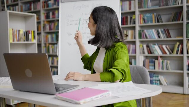 Cheerful Asian teacher conducts online English classes