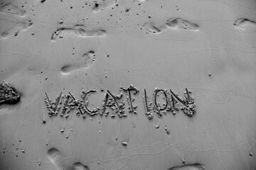 Words Vacation on the beach sand