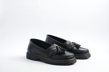 A pair of leather elegant shoes on a white background. Selective focus shoes