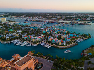 Fototapeta premium Harborside Villas aerial view with sunset twilight at Nassau Harbour with Nassau downtown at the background, from Paradise Island, Bahamas.