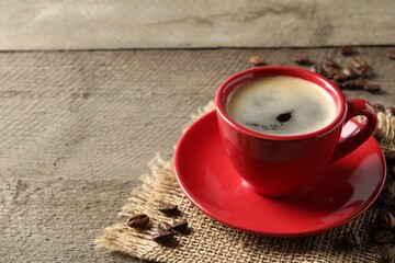Cup of aromatic coffee on wooden table. Space for text
