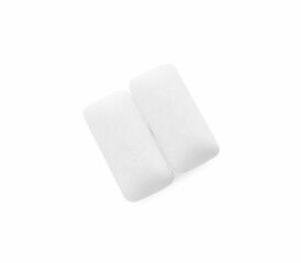 Two pieces of chewing gum on white background, top view